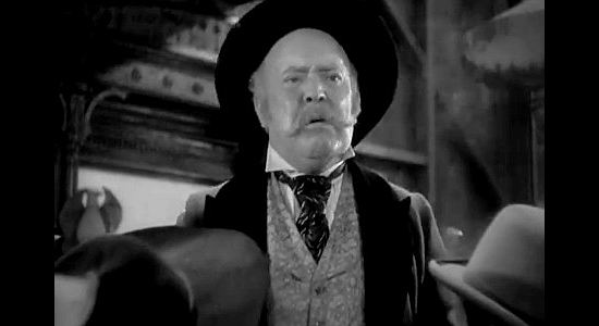 Guy Kibbee as Dr. Daniel Blake, convincing Fort Allen men to put their money in the Standish bank in The Conquerors (1932)