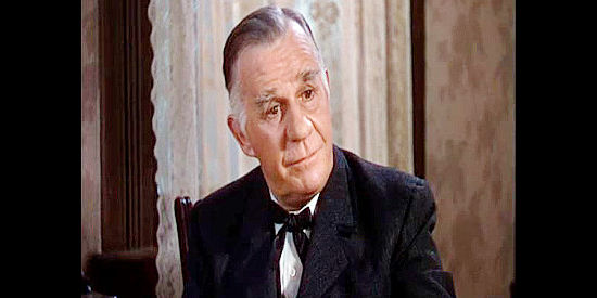 Henry Travers as Dr. Irving, hearing Wade Hatton's explain how Lee Irving died in Dodge City (1939)
