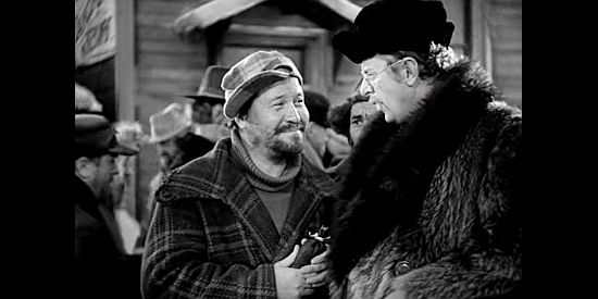 Jack Oakie as Shorty Hoolihan, encouraging Mr. Smith (Reginald Owen) to pay off a lost bet in Call of the Wild (1935)