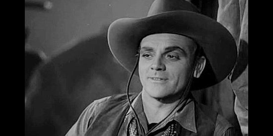James Cagney as Jim Kincaid, aka The Oklahoma Kid, catching a first glimpse of Jane Hardwick in The Oklahoma Kid (1939)