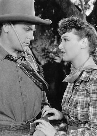 James Cagney as Jim Kincaid (aka The Oklahoma Kid) with Rosemary Lane as Jane Hardwick in The Oklahoma Kid (1939)