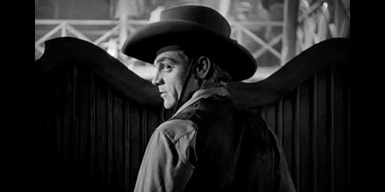James Cagney as The Oklahoma Kid, facing the prospect of trouble in a saloon in The Oklahoma Kid (1939)