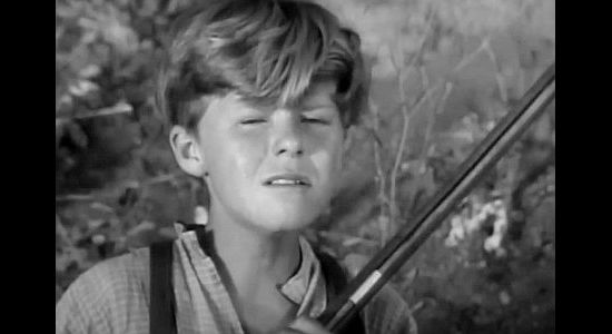Jay Ward as young Lynn Hayden, reacting to his grandfather's death and holding the rifle he's supposed to use to kill members of the Colby clan in To the Last Man (1933)