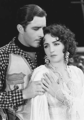 John Boles as Capt. Jim Stewart with Bebe Daniels as Rita Ferguson in Rio Rita (1929)