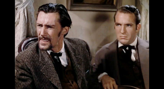 John Carradine as Bob Ford and Charles Tannen as his brother Charles, visiting Mr. Howard in Jesse James (1939)
