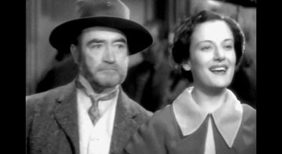 John Sheehan as saloon owner Ed Barrow and Dorothy Tree as saloon girl Blackie Winters, arriving at the church social in Three Godfathers (1936)