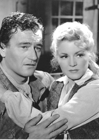 John Wayne as Jim Smith and Claire Trevor as Janie MacDougall in Allegheny Uprising (1939)