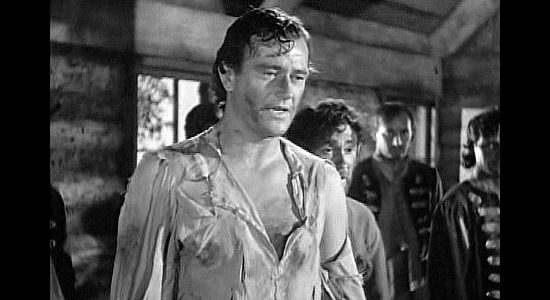 John Wayne as Jim Smith, finding himself part of a prisoner exchange in Allegheny Uprising (1939)