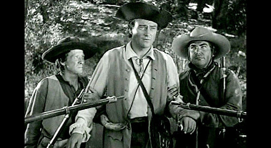 John Wayne as Jim Smith, surrounding by Callendar's men in Allegheny Uprising (1939)