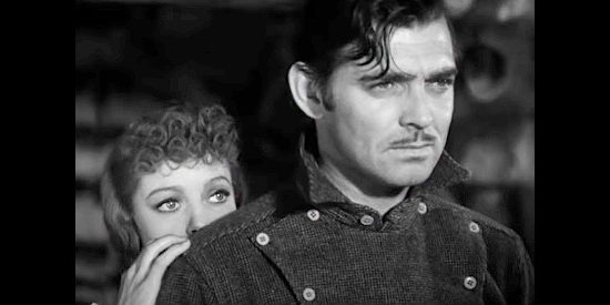 Loretta Young as Claire Blake, hiding behind Jack Thornton (Clark Gable) when the claim jumpers show up in Call of the Wild (1935)