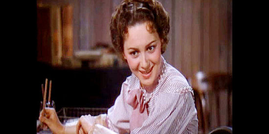Olivia de Havilland as Abbie Irving, explaining her desire to be a newswoman in Dodge City (1939)