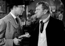 Dennis O'Keefe as Jeff Burton holding a gun on Trigger Bill (Wallace Beery) in The Bad Man of Brimstone (1937)