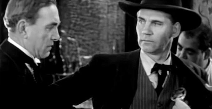 Harry Carey as Ed Brandt, learning the Frame Johnson (Walter Huston) has pinned on another badge in Law and Order (1932)