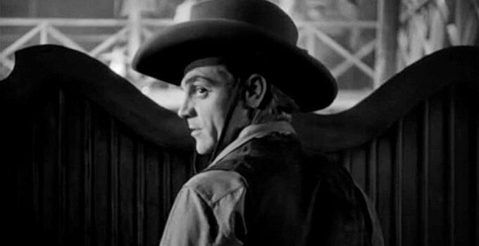 James Cagney as The Oklahoma Kid, facing the prospect of trouble in a saloon in The Oklahoma Kid (1939)