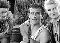 John C. Hamilton as Professor, John Wayne as a wounded Jim Smith and Claire Trevor as Janie MacDougall in Allegheny Uprising (1939)