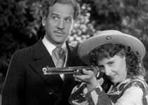 Melvyn Douglas as Jeff Hogarth watching Annie Oakley (Barbara Stanwyck) show off for European royalty in Annie Oakley (1935)