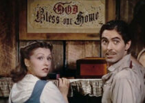 Nancy Kelly as Zee and Tyrone Power as Jesse, admiring their God Bless This Home sign in Jesse James (1939)