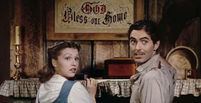 Nancy Kelly as Zee and Tyrone Power as Jesse, admiring their God Bless This Home sign in Jesse James (1939)