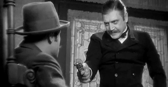 Richard Dix as Roger Standish, holding a gun on a bank customer demanding money Standish doesn't have in The Conquerors (1932)