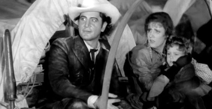 Richard Dix as Yancey Cravet, Irene Dunne as Sabra and their young son Cim arriving in Osage in Cimarron (1931)