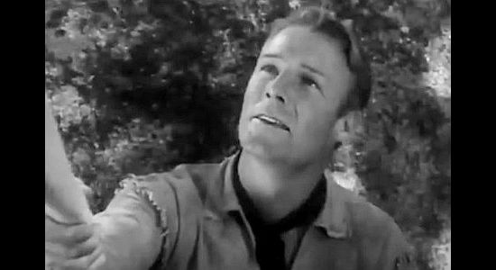 Randolph Scott as Lynn Hayden, learning the pretty girl he just met is a member of the Colby clan in To the Last Man (1933)