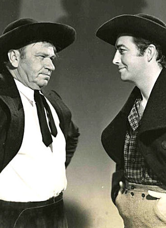 Wallace Beery as Capt. Boss Starkey and Robert Taylor as Blake Cantrell in Stand Up and Fight (1939)