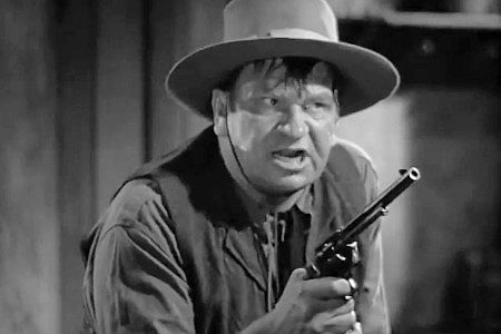 Wallace Beery as Trigger Bill, in the middle of an argument with partner Portuguese Ben in The Bad Man of Brimstone (1937)