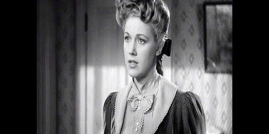 Audrey Long as Clara Cardell, looking for Rocklin's help when she loses trust in Miss Martin and Judge Garvey in Tall in the Saddle (1944)