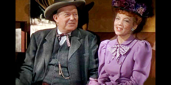 Evelyn Keyes as Hannah Brockway with her father Nahan (Willard Robertson), on the way home from a wedding shopping trip in Renegades (1946)