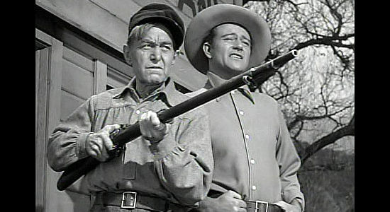 Harry Carey as Al Destry and John Wayne as Roy Glennister, denying officials access to their mine in The Spoilers (1942)