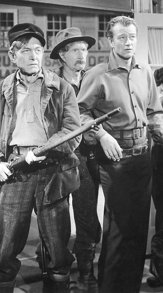 Harry Carey as Dextry, Russell Simpson as Flapjack Sims and John Wayne as Roy Glennister in The Spoilers (1942)