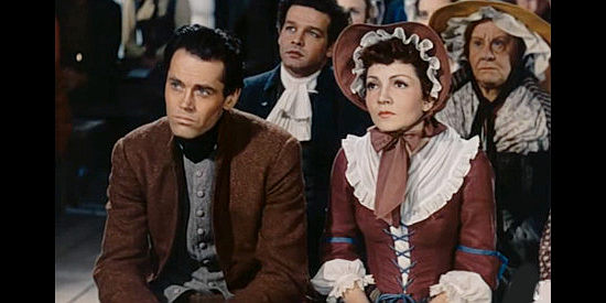 Henry Fonda as Gil Martin and Claudette Colbert as Lana listen to a warning from their reverend in Drums Along the Mohawk (1939)