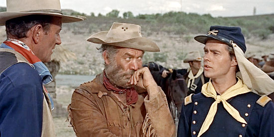 Hondo (John Wayne) and Buffalo Baker (Ward Bond) discuss riding deeper into Apache country with Lt. McKay (Tom Irish) in Hondo (1953)