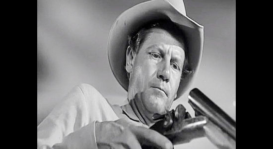 Joel McCrea as Dave Nash, loading his shotgun while preparing for a showdown in Ramrod (1947)