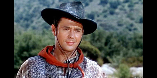 Larry Parks as Ben Dembrow, showing up in the nick of time to save Hannah from a stage holdup orchestrated by his outlaw kin in Renegades (1946)