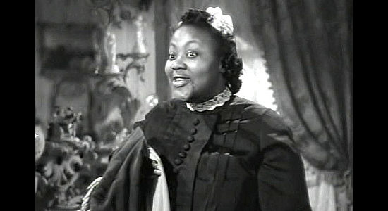 Marietta Canty as Idabelle, knowing Cherry Malotte will want to have a special treat waiting for Glennister's homecoming in The Spoilers (1942)