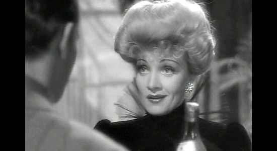 Marlene Dietrich as Cherry Malotte, using her charm on gold commissioner McNamara in The Spoilers (1942)