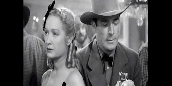Miriam Hopkins as Julia Hayne and Randolph Scott as Vance Irby, talking about their plans in Virginia City (1940)