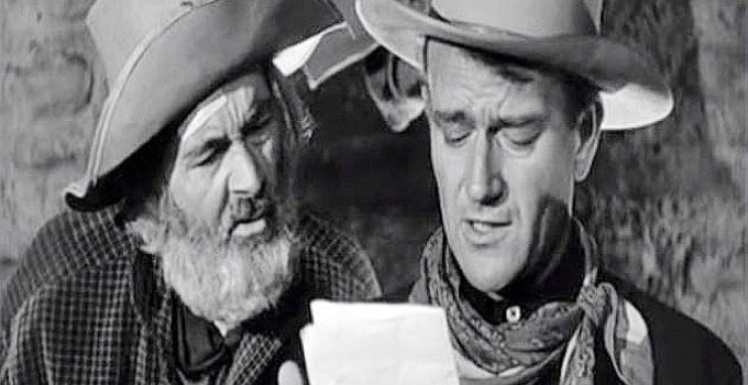 Gabby Hayes as Dave and John Wayne as Rocklin in Tall in the Saddle (1944)
