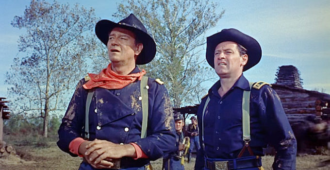 John Wayne as Col. John Marlowe and William Holden as Maj. Henry Kendall, watching Southern troops advance in The Horse Soldiers (1959)