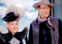 Martha Scott as Catherine Allen with John Wayne as Daniel Somers, arriving in Oklahoma in War of the Wildcats (1943)