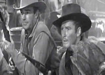 Randolph Scott as Vance Irby and Errol Flynn as Kerry Bradford, fighting off an Indian attack in Virginia City (1940)