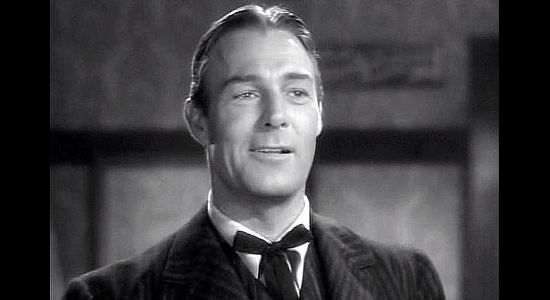 Randolph Scott as new gold commissioner Alexander McNamara, liking what he sees when he meets Cherry Malotte in The Spoilers (1942)