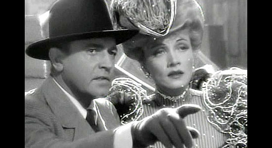 Richard Marthelmess as Bronco, pointing out Glennister coming ashore with another woman as Cherry Malotte (Marlene Dietrich) watches in The Spoilers (1942)