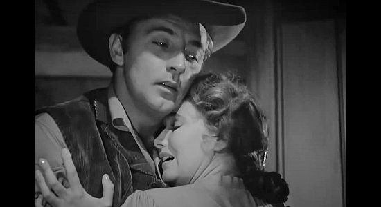 Robert Mitchum as Jeb Rand and Teresa Wright as Thorley Callum, saying goodbye as he heads off to war in Pursued (1947)