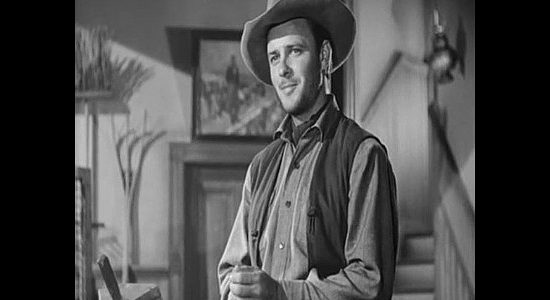 Robert Sterling as Clay Phillips, stocking up on ammunition and watching over his younger brother in Roughshod (1949)