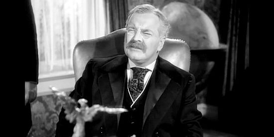 Sidney Blackmer as Teddy Roosevelt, hearing propositions from Jim Gardner and Daniel Somers in War of the Wildcats (1943)