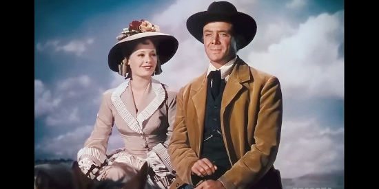 Virginia Gilmore as Sue Creighton and Dean Jagger as Edward Creighton, watching the wagons roll westward in Western Union (1941)