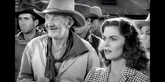 Walter Brennan as Groot Nadine and Joanne Dru as Tess Millay, watching a brawl in Red River (1948)