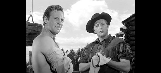 William Holden as David Harvey and Robert Mitchum as Jim Fairways, the latter getting his first glimpse of Rachel in Rachel and the Stranger (1948)